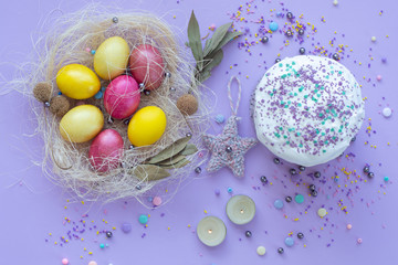 beautiful beautiful Easter composition in purple tones with painted eggs and cake