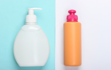 Shampoo and gel bottles on blue white background. Skin and hair care. Hygiene and cosmetics. Beauty flat lay. Top view