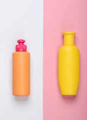 Shampoo and gel bottles on pink white background. Skin and hair care. Hygiene and cosmetics. Beauty flat lay. Top view