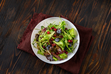 Bowl of fresh lettuce with berries