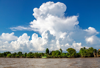 Beautiful cumulus clouds over the tributary of the Mekong River, Vietnam. Asia