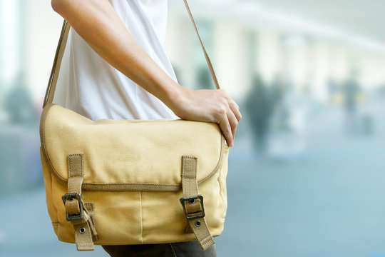 Man using shoulder bag for travelling