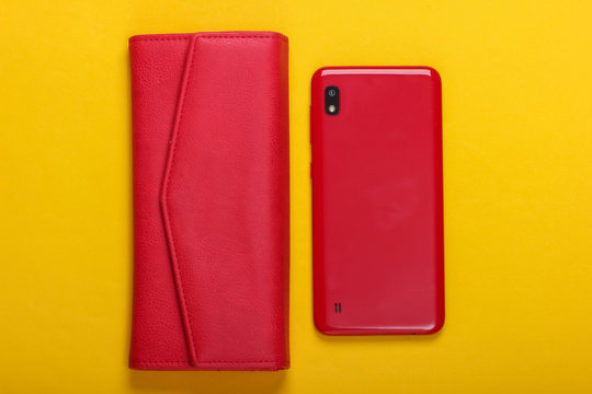 Smartphone With Leather Wallet On Yellow Background. Top View