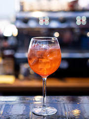 Aperol is an alcoholic cocktail. Orange. Cold drink with ice cubes. The glass is on the bar. Refreshing cocktail for hot weather. Menu for restaurants, cafes and bars.