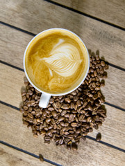 a cup of coffee on wooden table