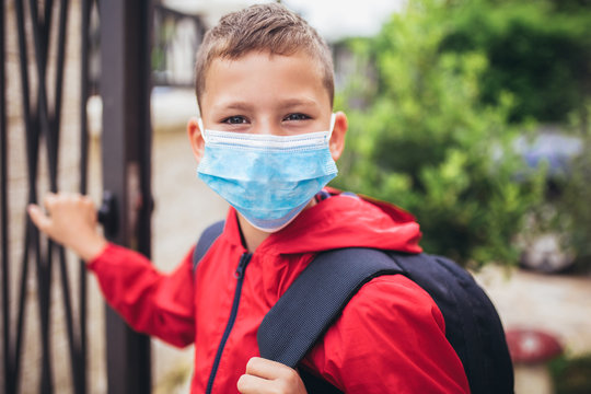Child wear facemask during coronavirus and flu outbreak. The boy wear a mask before going to school preventing outbreak Infectious disease and dust in the air.