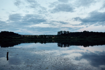 Large pond in the evening in the village