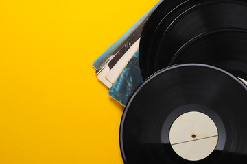 Vinyl record albums isolated on yellow background. Copy space. Top view