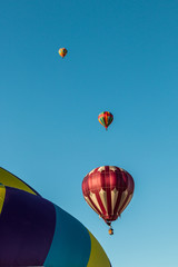 Fototapeta na wymiar Colorful Hot Air Balloons In Flight At The Pahrump BalloonFest, Pahrump, Nevada, USA