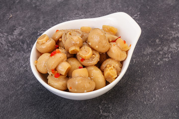 Pickled champignons in the bowl