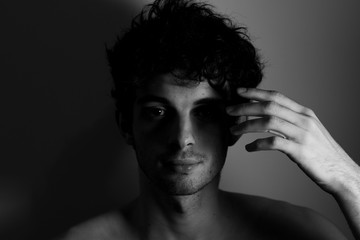 Young man teenager touching head hand curly hear