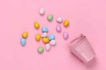 Mini bucket with easter eggs on a pink pastel background. Easter minimalism. Pastel color trend