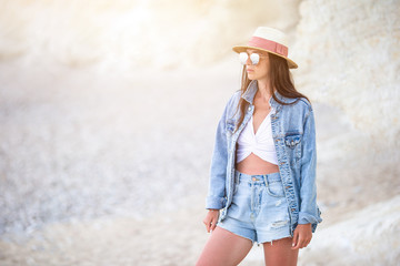 Young beautiful woman on white tropical beach.