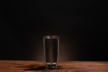 glass of pure water on dark background