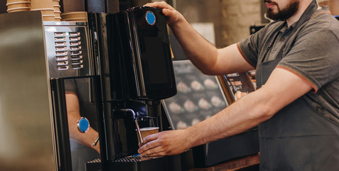 Barista making coffee using coffee machine