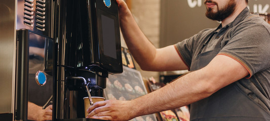 Barista making coffee using coffee machine