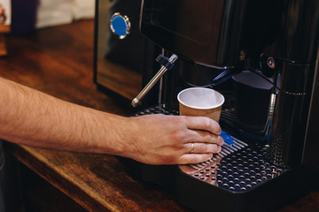 Fototapeta na wymiar Barista making coffee using coffee machine