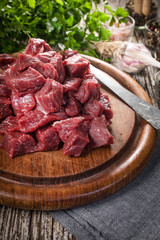 Beef stew prepared on a chopping board.