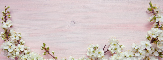 Spring flowering branch on wooden background. Copy space.
