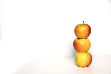 a pile of three apples isolated on white background