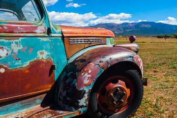 Old Multicolored Pickup  With Mountains, Taos, New Mexico, USA © Billy McDonald