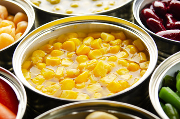 Canned sweet corn in just opened tin can. Non-perishable food