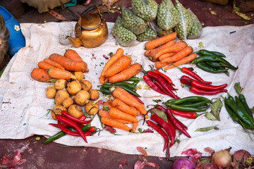 Carrots, potatoes, red and green peppers and kettle on street market, Morocco 