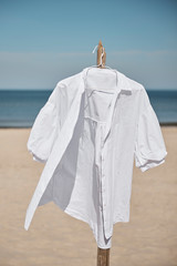 White blouse on a beach - obrazy, fototapety, plakaty