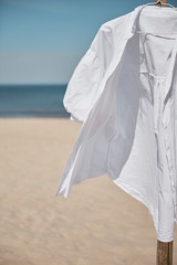 White blouse on a beach - obrazy, fototapety, plakaty