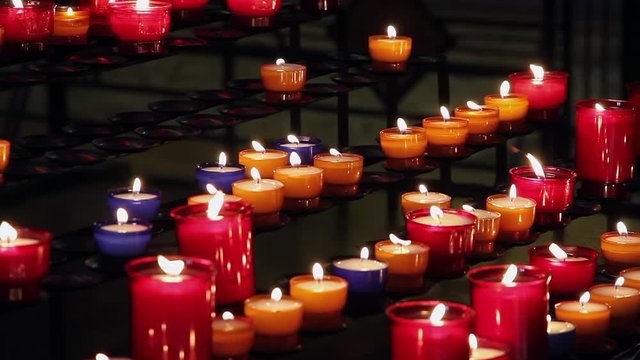 LISIEUX, FRANCE - JUNE 18, 2010: Colored burning candles in the church