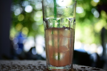 Pink cocktail with ice and mint, selective focus