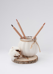Vintage ceramic pot, cotton flower, wooden circle on white background. Suitable for advertising natural cosmetics, postcards, invitations, or printing