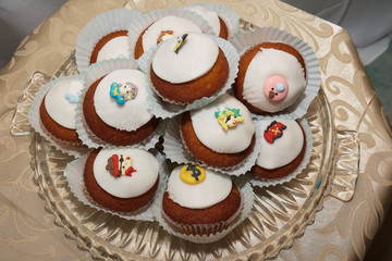 Pile of nicely Decorated muffins cupcakes with white sugar fondant paste and toys for birthday party. Maritime nautical theme aesthetic idea. Ocean sea life. Sweet snacks for kids event celebration.