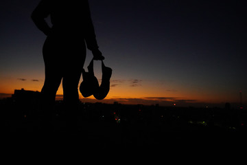 Silhouette of female boxer in the city sunset