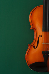 Classical music concert poster with brown color violin on dark green background with copy space for...