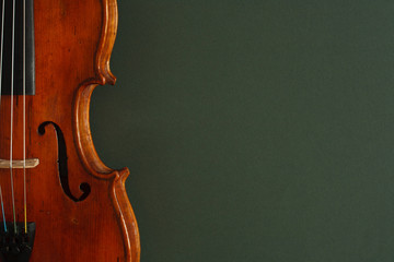 Classical music concert poster with brown color violin on dark green background with copy space for your text  © Mikalai