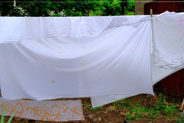 
Sheets hang on a rope and dry