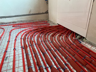Laying pipes for underfloor heating. Floor heating system when connected. Connection of heating in the house.