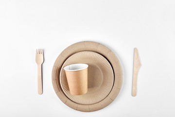 Disposable tableware made of environmental materials. Eco-friendly cookware, zero waste production from recycled materials. Paper plates, glasses, cocktail tubes. Wooden forks and knives. 
