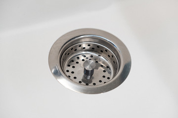 Fresh and clean white sink and silver water filter. Close up