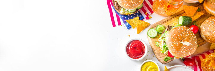 Celebrating Independence Day, July 4. Traditional American Memorial Day Patriotic Picnic with burgers, french fries and snacks, Summer USA picnic and bbq concept, White concrete background