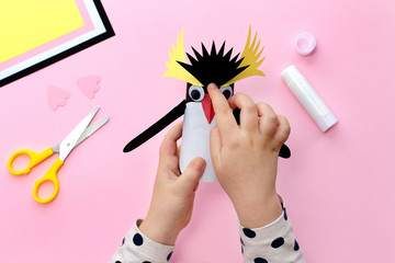 Making a penguin from colored paper and a roll of toilet paper. Children's art project. Step by step photo instruction. Step 8. Glue black crest