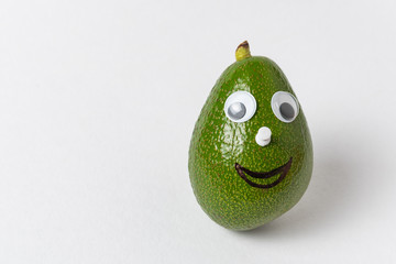 Fun avocado with Googly eyes and smile on white background. Avocado character