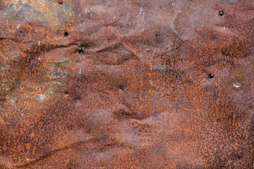 Brown rusted and scratched metal surface texture