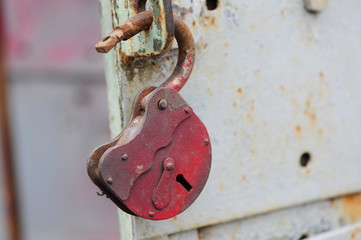 Close up, padlock hanging at vintage door