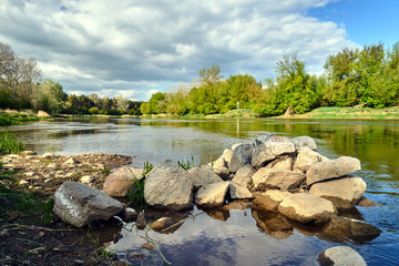 Fototapeta na wymiar Stone spur on the Warta river in Poland.