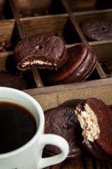 Sweet snack with coffee. White Cup of coffee and half-eaten Choco pie.