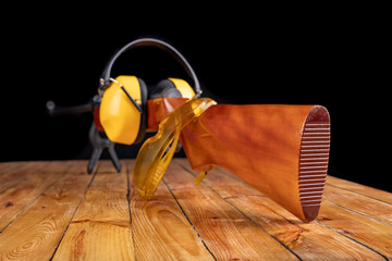 Pneumatic weapon and accessories on a wooden table. Shooting accessories.