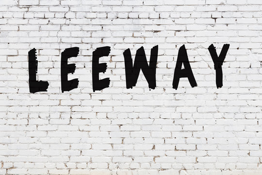 White wall with black paint inscription leeway on it