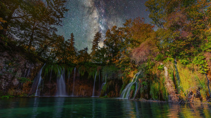 Wonderful night with milky way up the pure water waterfall on Plitvice National Park. Colorful spring panorama of green forest with blue lake. Great countryside view of Croatia, Europe. Travel concept